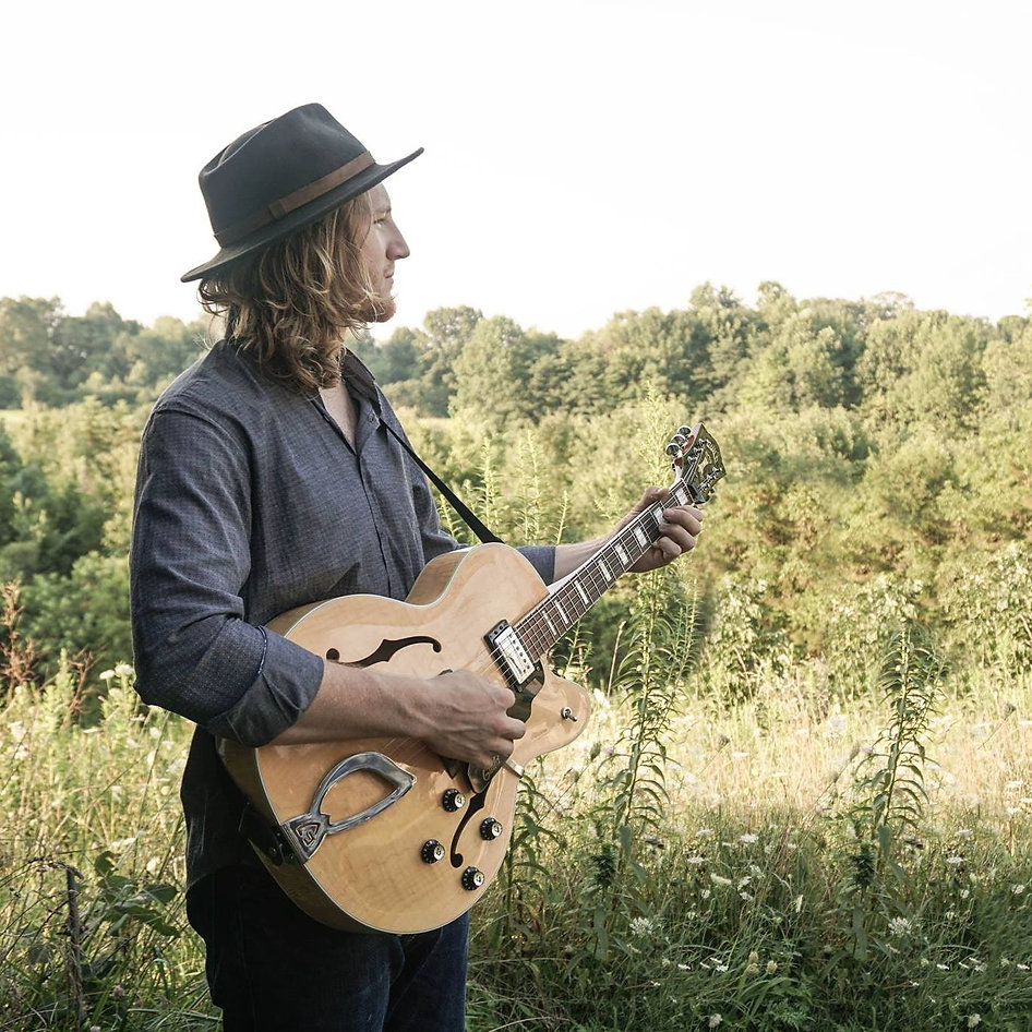 Jackson holding guitar